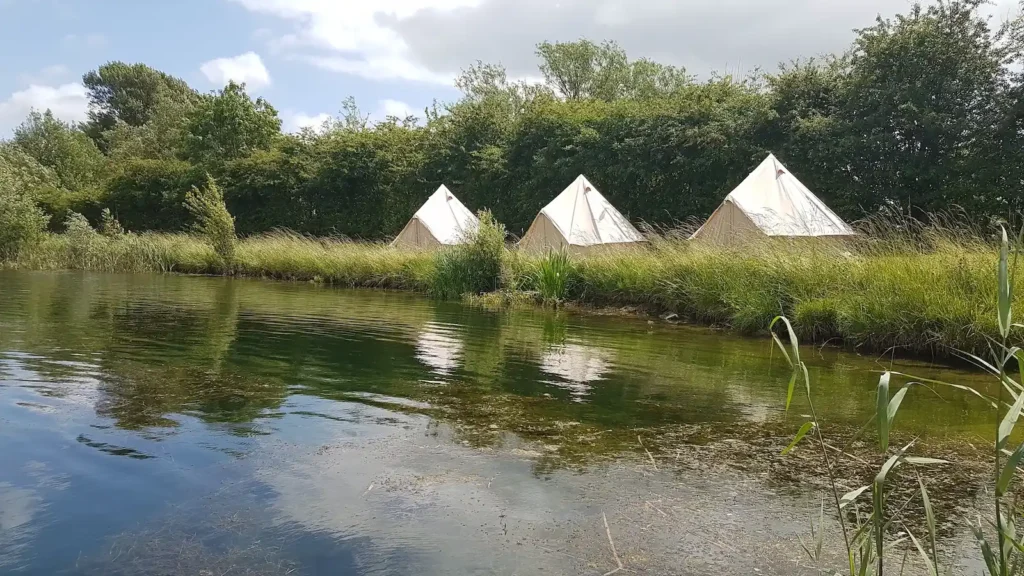 Bell Tents set out around a lake in South Cerney, near Cirencester