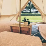 Bell tent hire setup in Gloucestershire countryside for a summer event.