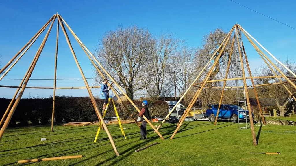 Giant Tipi being built. 9 x 8m poles